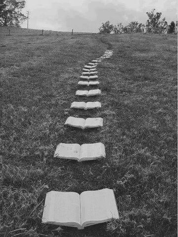 Black and white illustration of a long road beneath a wide sky.